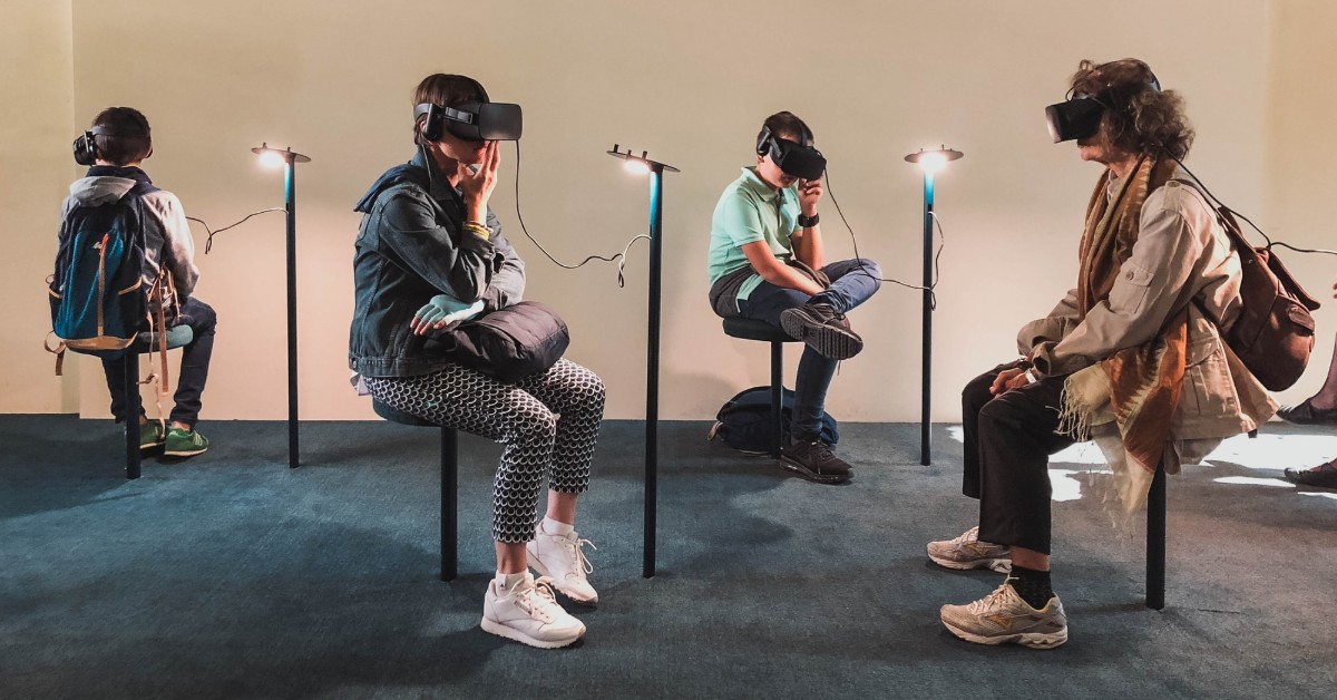 People sitting in a room wearing AR glasses.