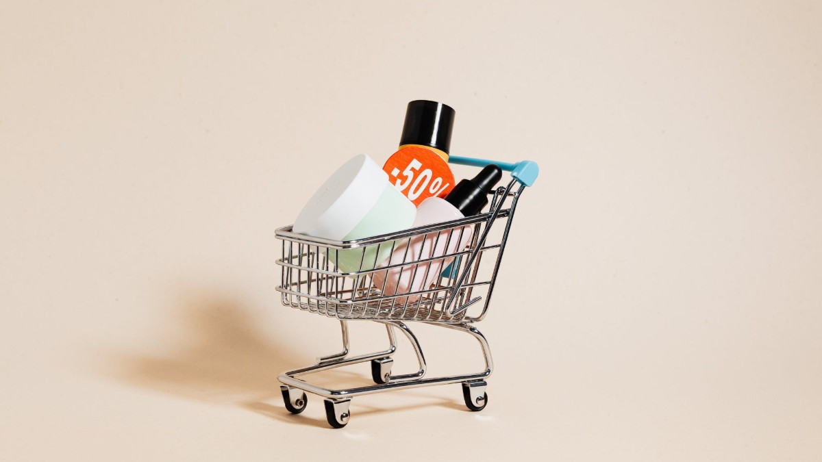 A toy shopping cart with products inside