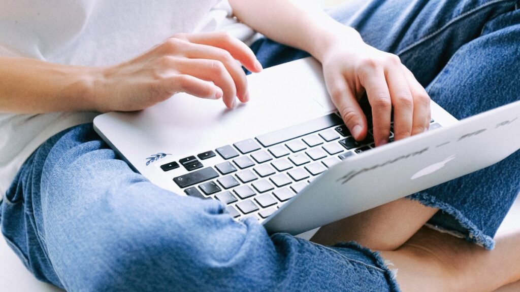 Person with computer in lap taking an online course.