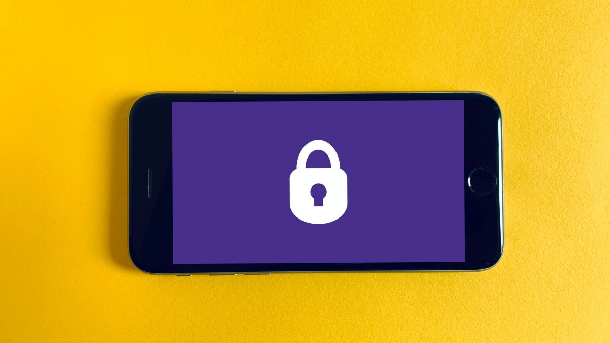 A smart phone with a purple screen showing a white lock on a yellow background.