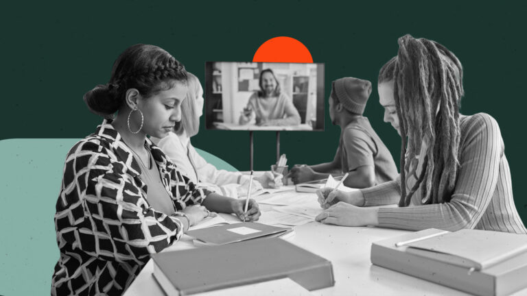 Virtual instructor on TV monitor teaching adult learners gathered at a table