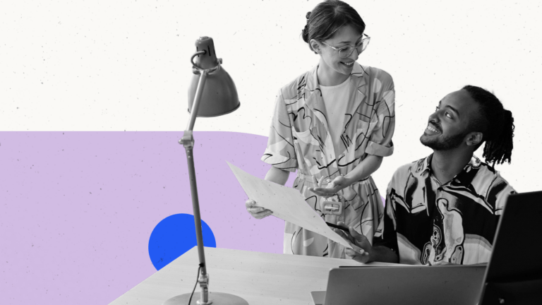 Two people looking at a report at a desk