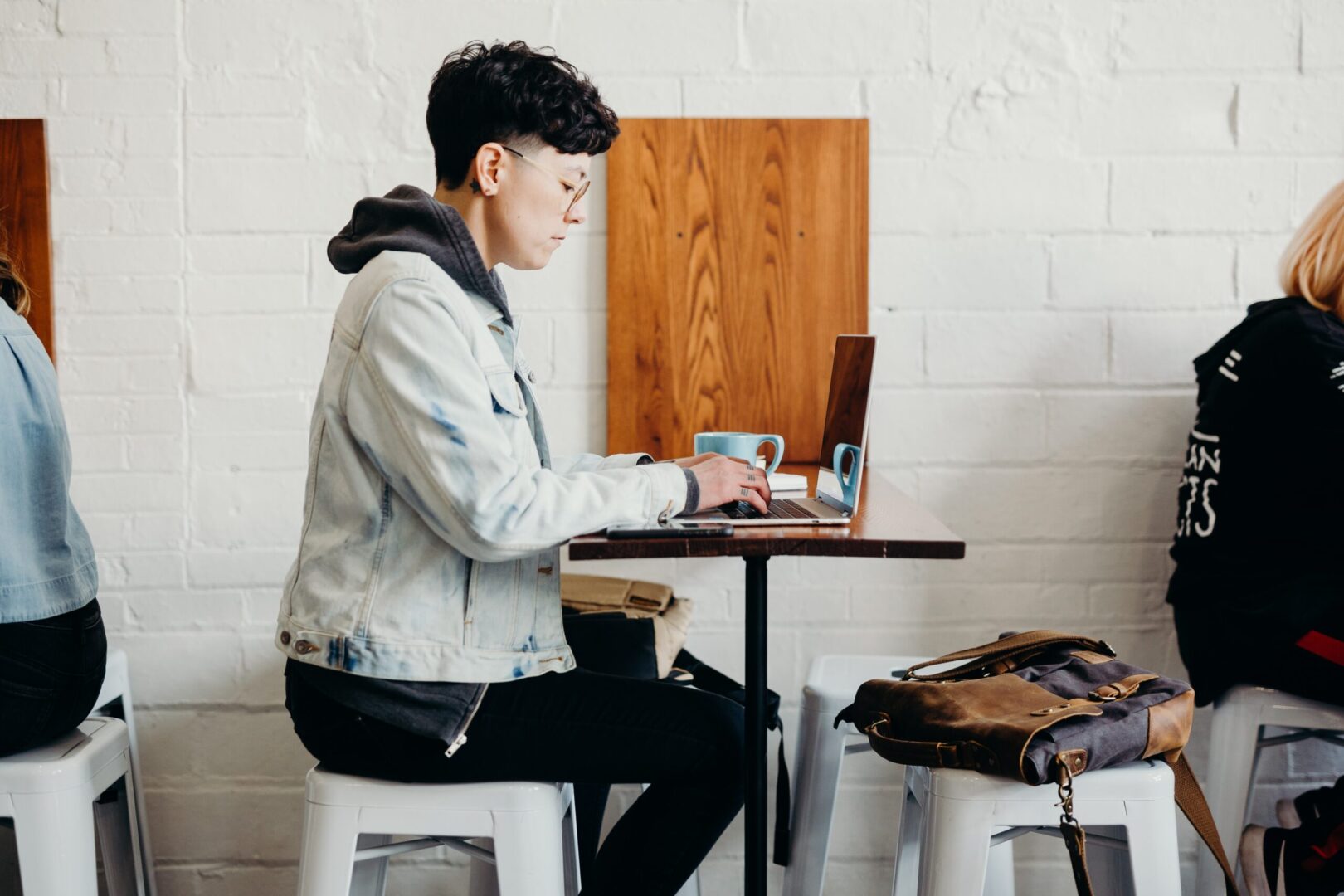 person using laptop on table in a cafe